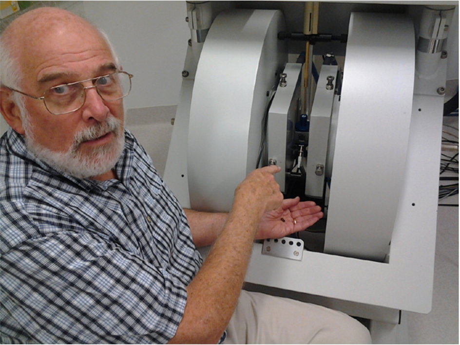 Larry Berliner working at the Bruker L-band/X-band in-vivo imaging spectrometer at the Centre for Advanced Imaging, University of Queensland. He is holding a coffee bean which was imaged at X-band on the basis of its paramagnetic radical content.