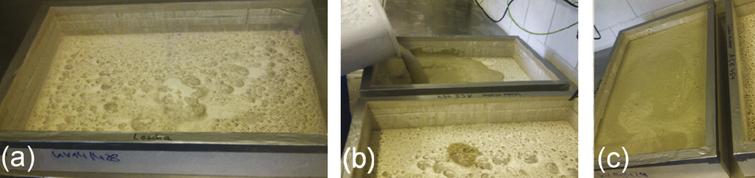 Manufacturing of UHPC-AAC small-scale samples. (a) Empty UHPC box with highly porous internal surface. (b) Cast of AAC slurry. (c) Swelling process of the AAC slurry driven by the aluminum reaction.