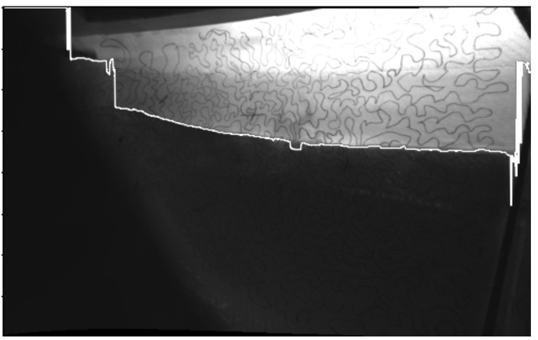 Waterline detection: from the edges detected in Fig. 8, the lowest pixels are selected using the assumption that the drawn pattern is not recognized below water level. In this figure, the detected waterline is drawn in white on top of the undistorted rectified left image of the stereo pair.