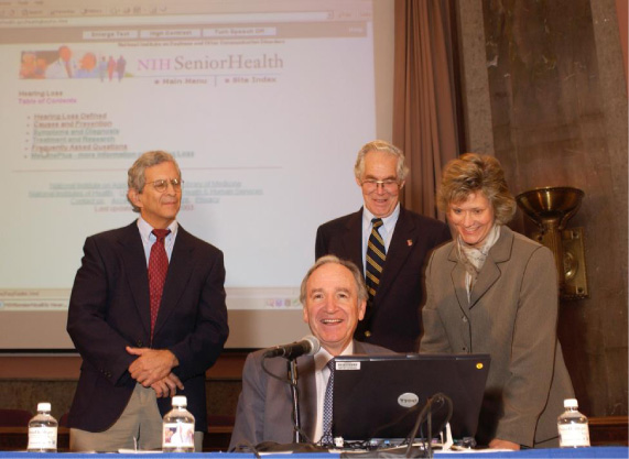 (From left to right). National Institute on Aging Director Richard J. Hodes, M.D., Senator Tom Harkin (D-IA), NLM Director Donald L.B. Lindberg, M.D., and Joyce Backus, Lead Systems Librarian, demonstrate and launch NIH Senior Health in an October 23, 2003, press briefing on Capitol Hill.