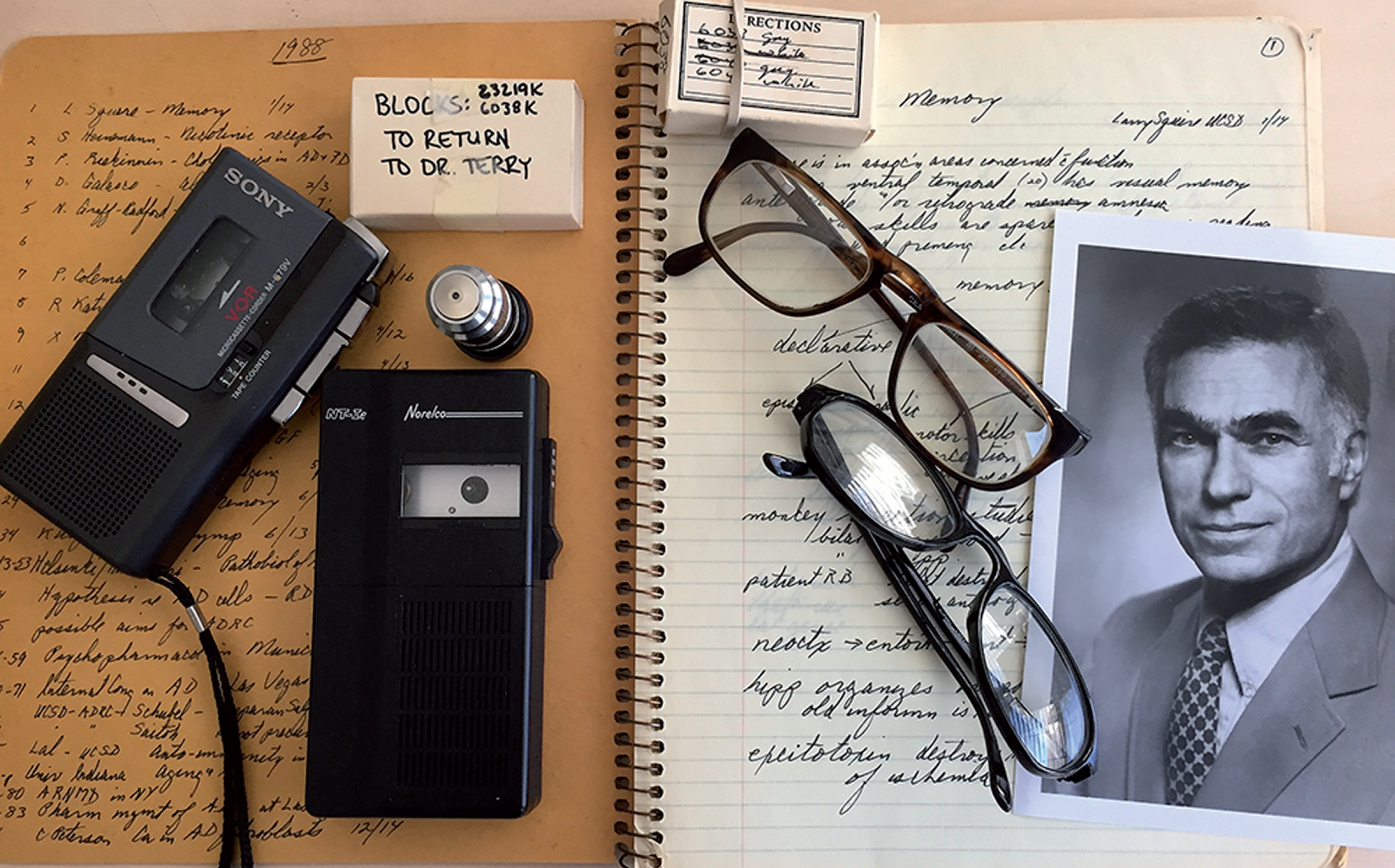 Some memorabilia from Bob Terry’s office at UCSD. His notebook, tape recorders, glasses, epon blocks for electron microscopy of Alzheimer’s disease brain biopsies from where the images of paired helical filaments were obtained, and a picture of him at his time at the Albert Einstein College of Medicine.