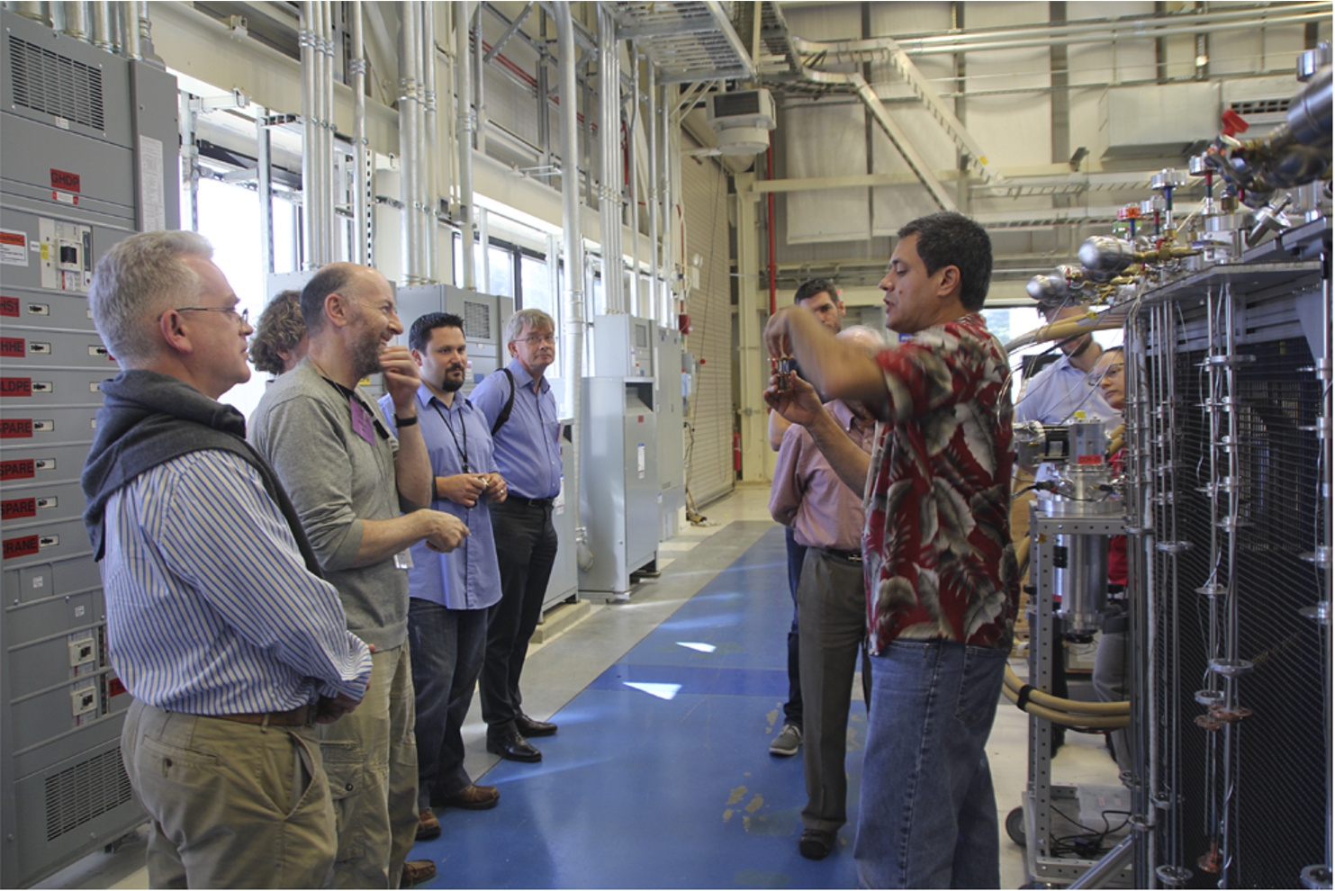 Participants visited the NIST Center for Neutron Research. Here, Juscelino Leão explains the specificities of special sample sticks.