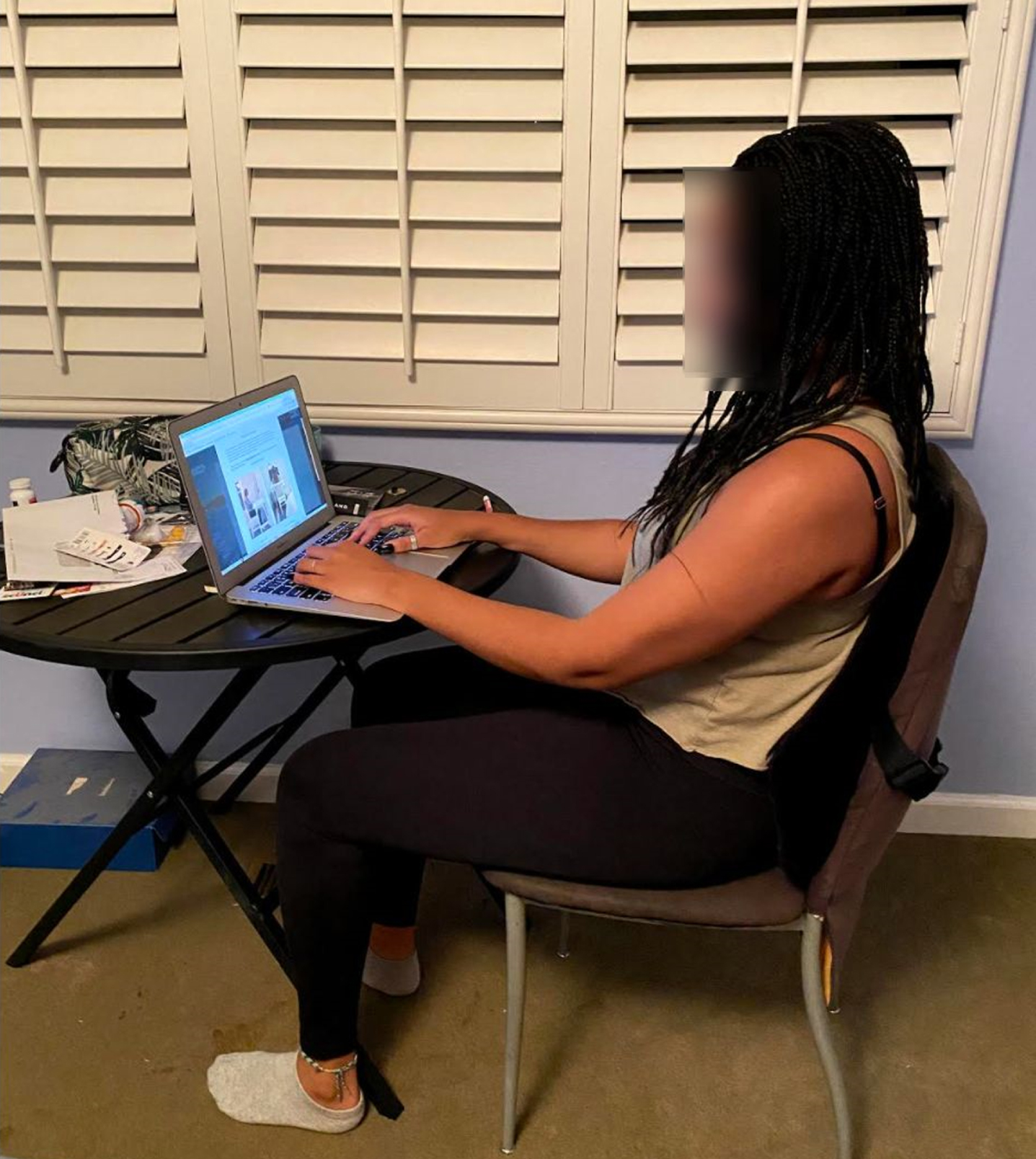 Participant at initial workstation. Example of a participant completely changing their workstation location from a family home to an apartment, resulting in many changes including a lumbar supportive chair, armrests, and laptop height, while making potentially unproductive changes such as facing a window.