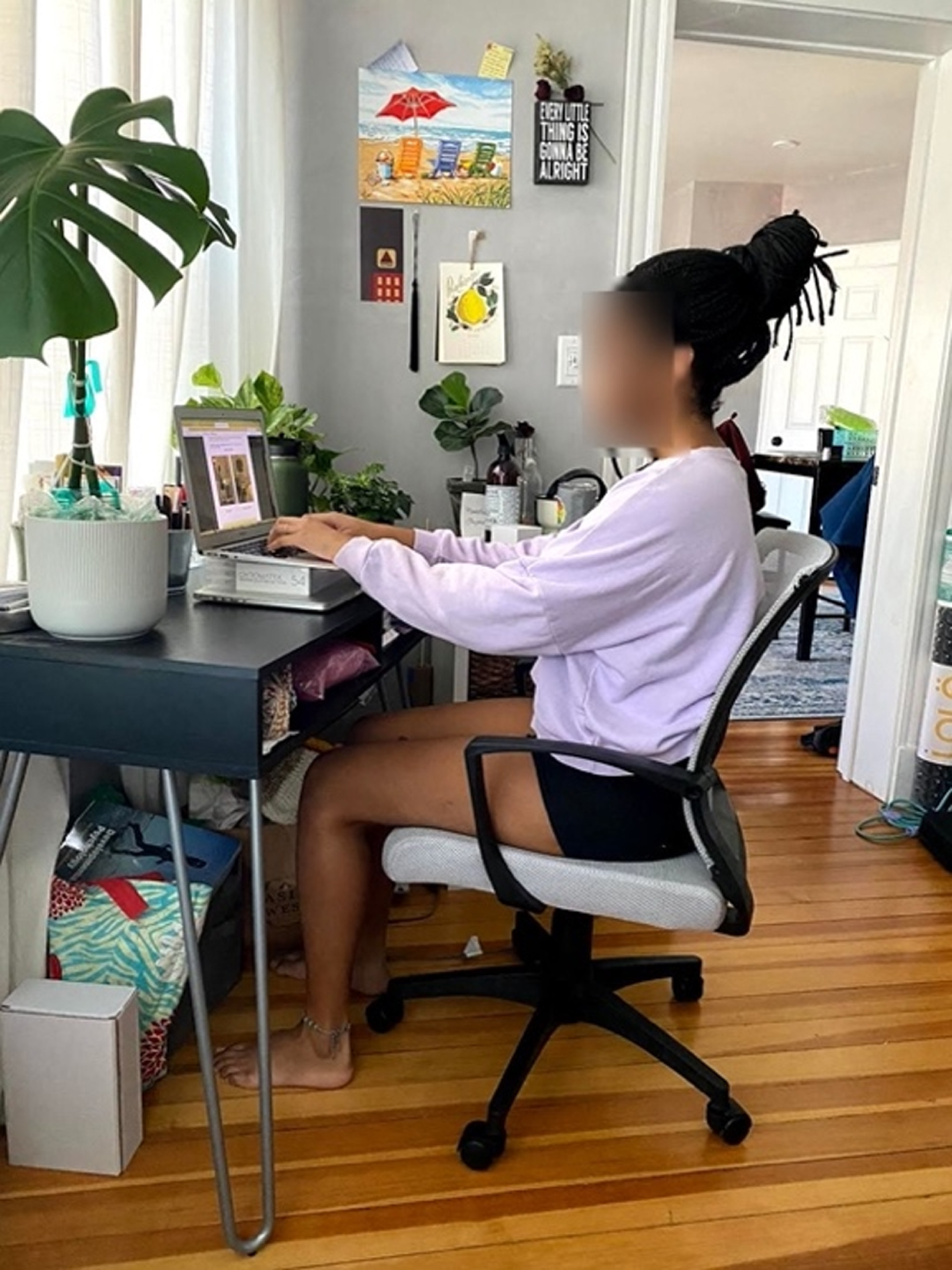 Participant at final workstation. Example of a participant completely changing their workstation location from a family home to an apartment, resulting in many changes including a lumbar supportive chair, armrests, and laptop height, while making potentially unproductive changes such as facing a window.
