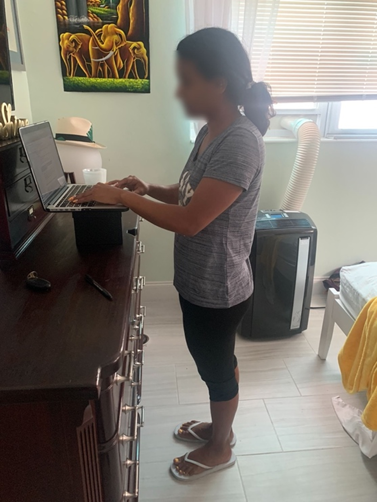 A participant used home objects to create a standing desk in her rotation of workstations.