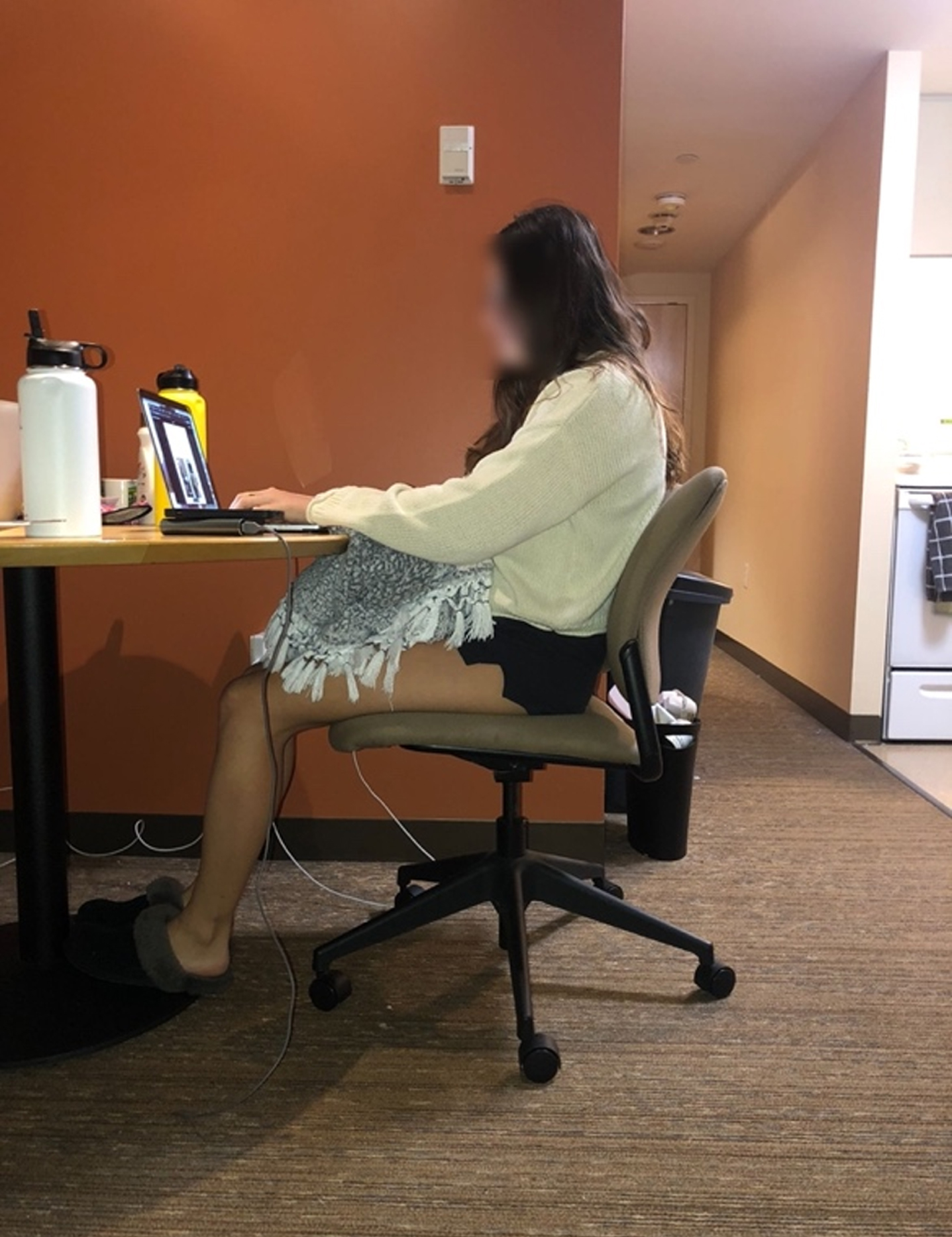 Chair with lumbar support. An example of a participant who made an improvement by raising her laptop and an ineffective change by selecting a different chair without lumbar support.